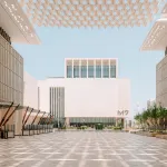 View of a white building, seen across a courtyard, that reads M7.
