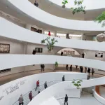 A spiraling rotunda with plants hung in its center.