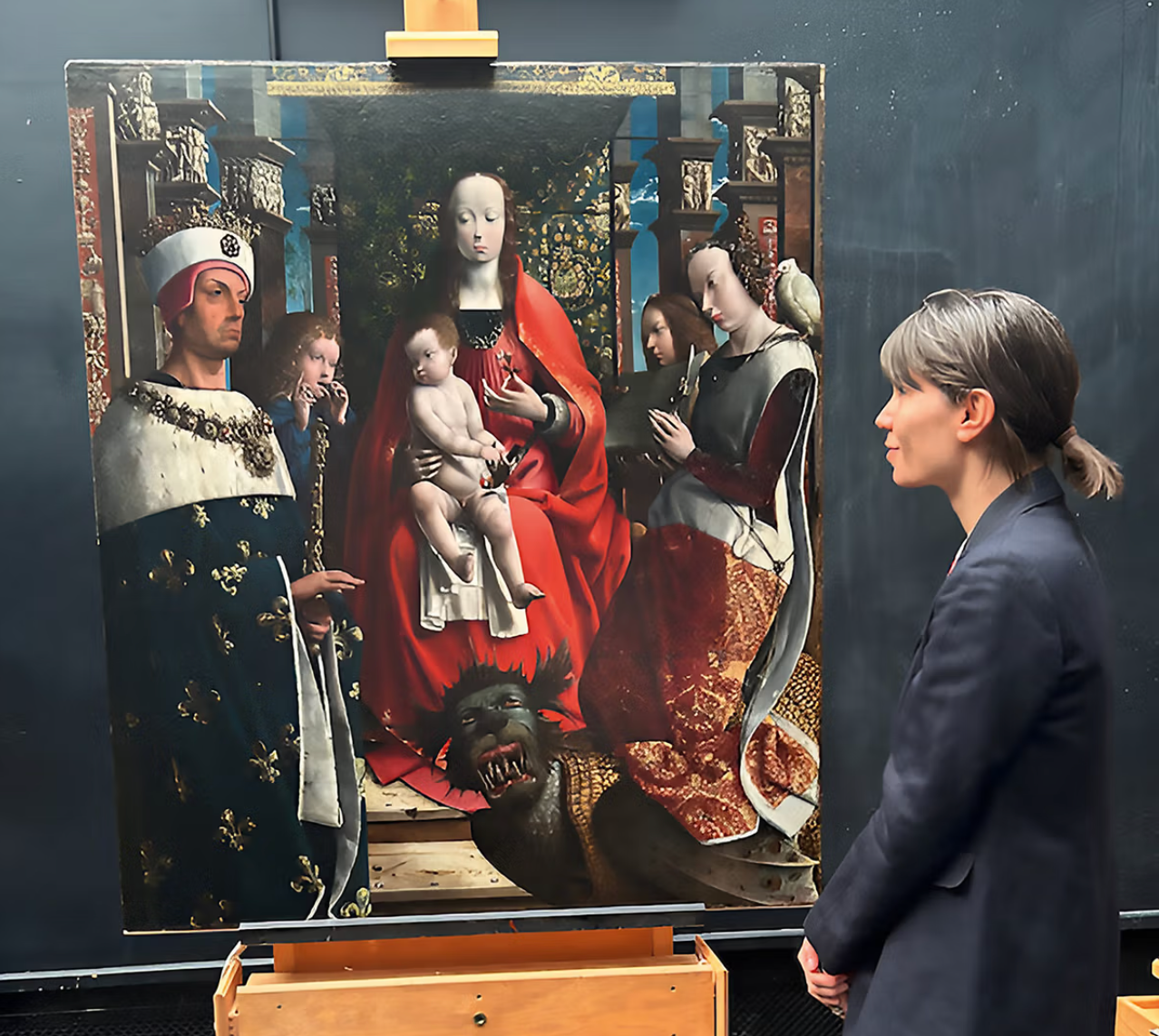 a woman admires a painting.