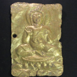 Gold plaque depicting Buddha.