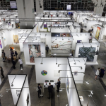 Aerial view of an art fair showing various booths.