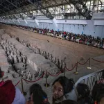 Tourists gather to see terra-cotta warriors at the Museum of Qin Terracotta Warriors and Horses in Xi