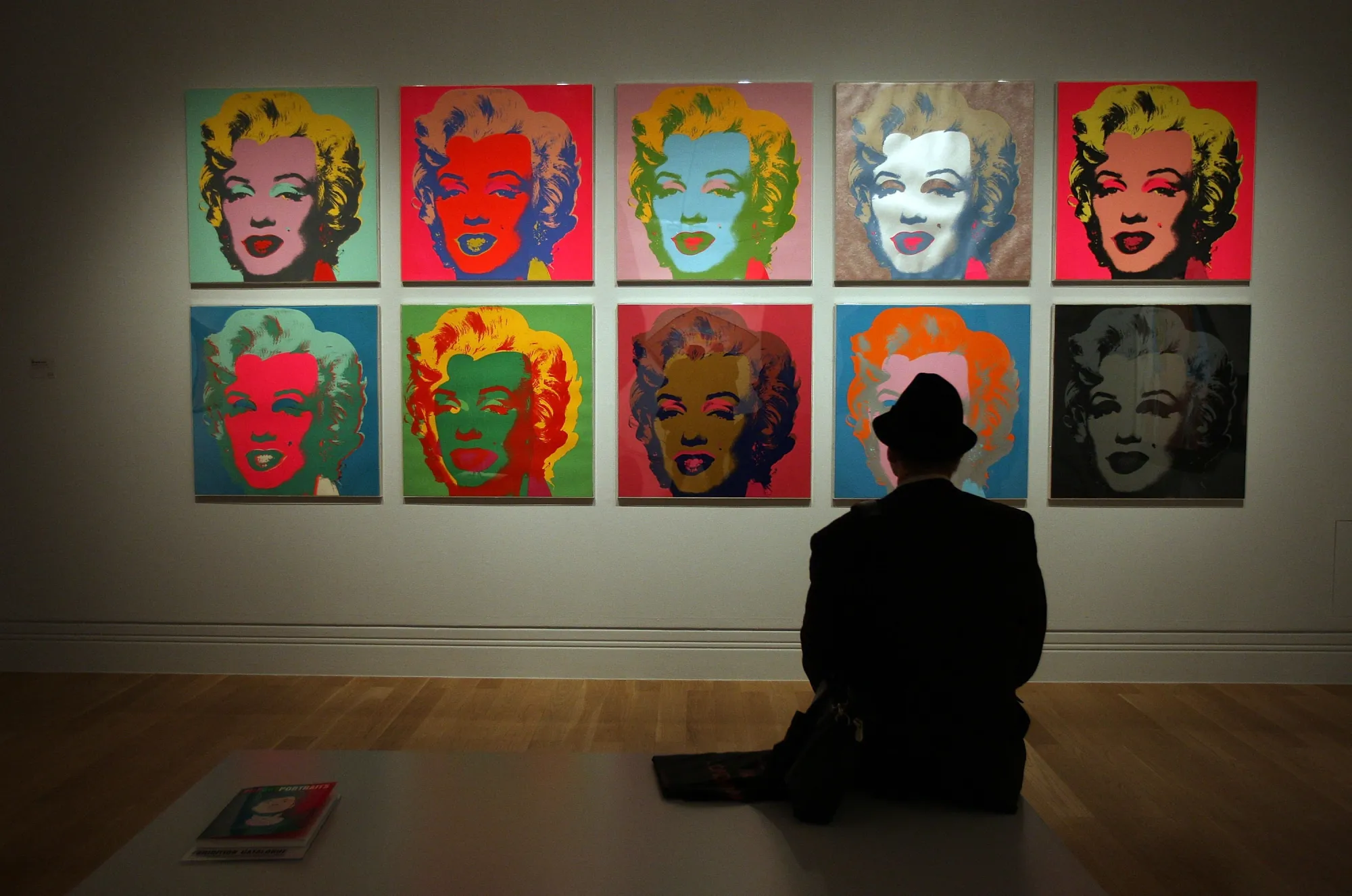 LONDON - OCTOBER 10: A visitor to the Pop Art Portraits exhibition at National Portrait Gallery looks at Andy Warhol