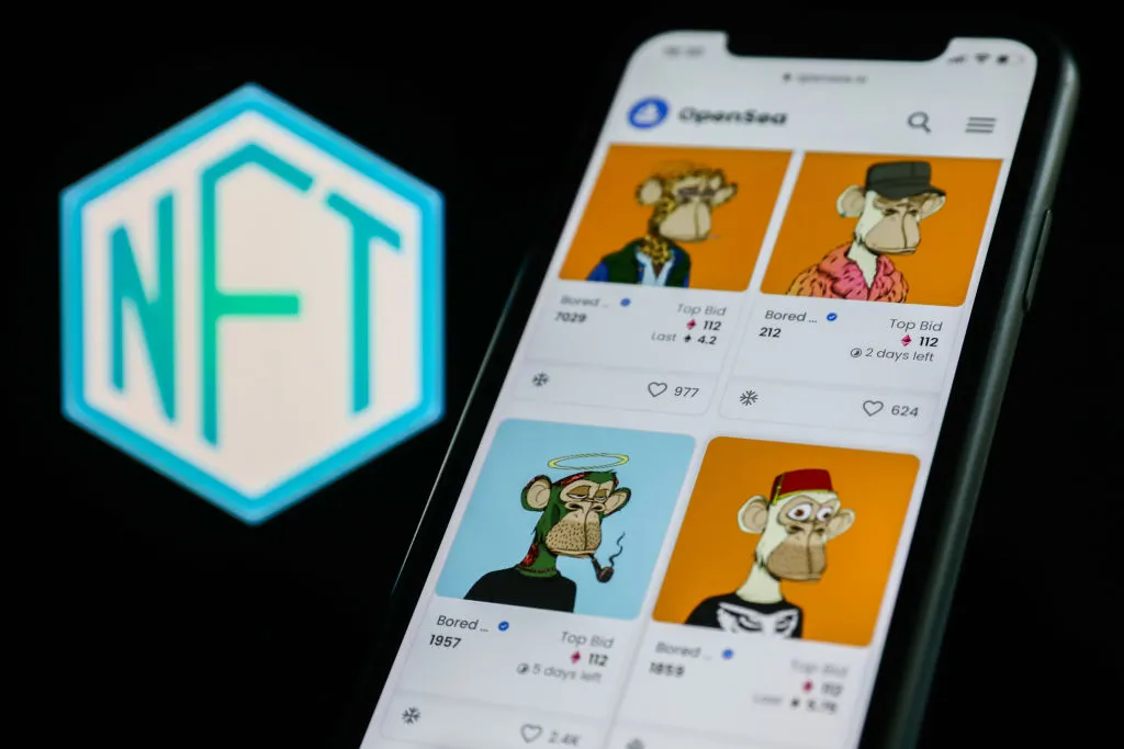 Bored Ape Yacht Club collection in OpenSea displayed on a phone screen and NFT logo displayed on a screen are seen in this illustration photo taken in Krakow, Poland on April 19, 2022. (Photo by Jakub Porzycki/NurPhoto via Getty Images)