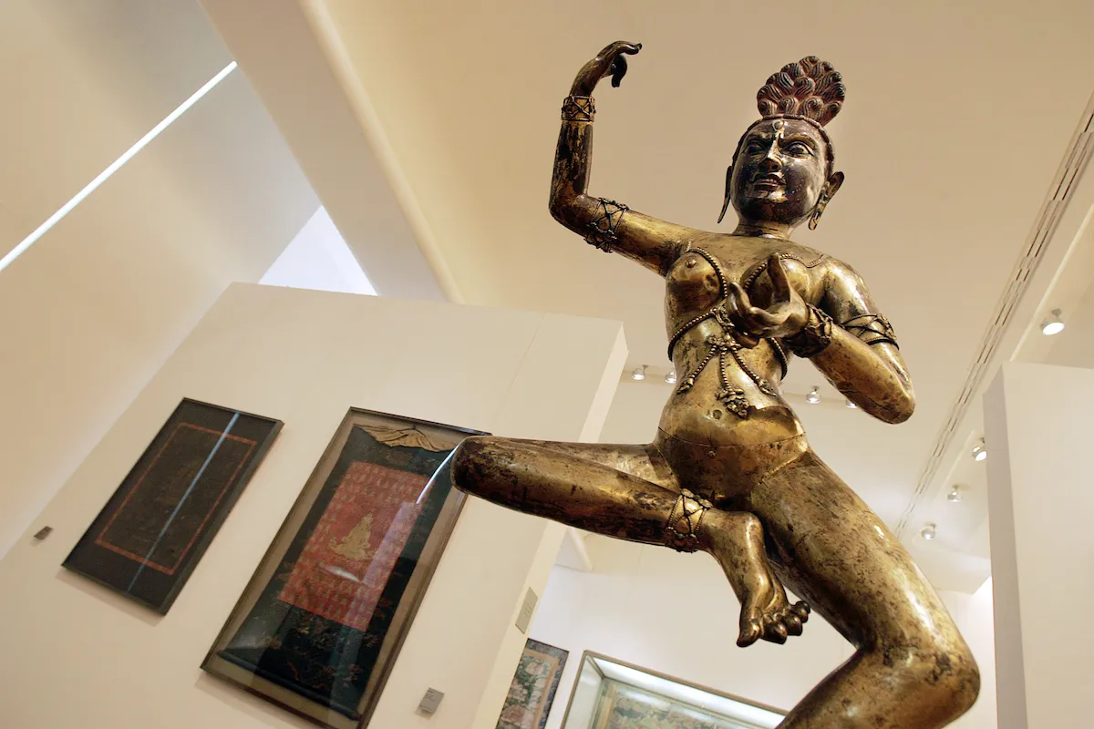 A golden statue of a dancing woman.