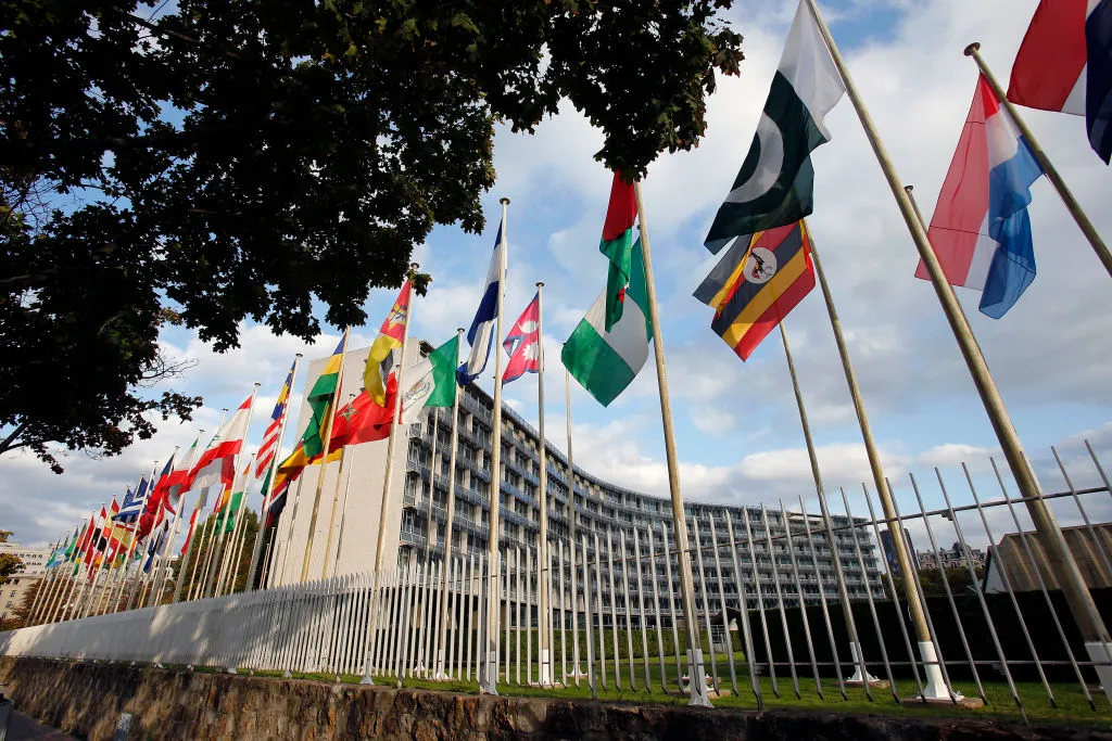 PARIS, FRANCE - OCTOBER 11: Flags from several countries float in front of the headquarters of the United Nations Educational, Scientific and Cultural Organization (UNESCO) on October 11, 2017 in Paris, France. From this Monday, the 58 members of the Executive Board of Unesco will vote by secret ballot at the headquarters of the organization to elect their new Director General. Several ballots are scheduled and the name of the new Director General of UNESCO will be announced on November 10. (Photo by Chesnot/Getty Images)
