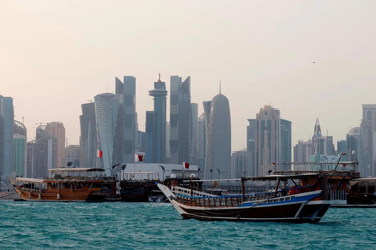Traditional dhow boats are anchored in front of the Doha skyline on July 5, 2025. (Photo by Karim JAAFAR / AFP) (Photo by KARIM JAAFAR/AFP via Getty Images)