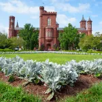 A brick castle-like structure in front of a grassy garden.