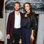 A man and a woman stand next to each other for a photo.