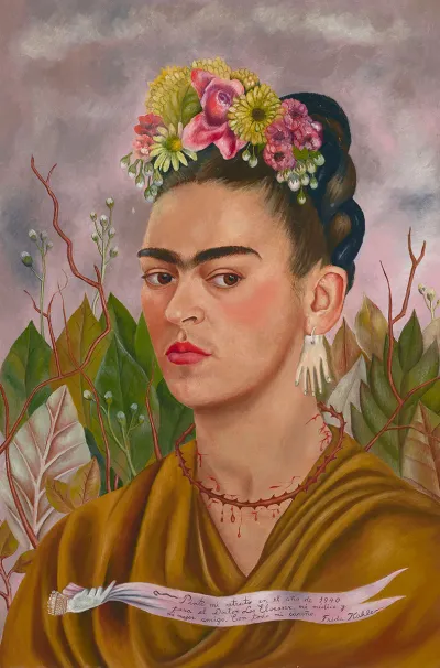 A painted self-portrait of Frida Kahlo with flowers in her hair and an earring of a hand. She has a necklace of thorns that draw blood from her neck. 