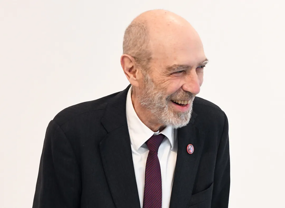 A smiling man in a suit.