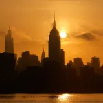 HOBOKEN, NJ - MAY 2: The sun rises behind the Empire State Building on May 2, 2025, as seen from Hoboken, New Jersey. (Photo by Gary Hershorn/Getty Images)