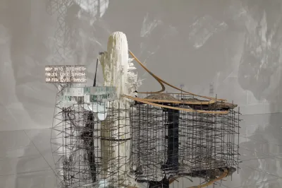An installation composed of a metal grate and wood elements, along with a sign reading 