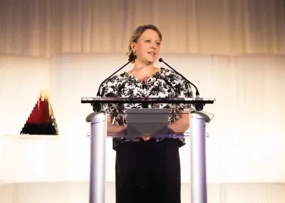 Nicola Lees at a podium. 