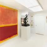 A large abstract Rothko painting hangs on a wall in a home, with a bronze sculpture in the center and a small Mondrian abstraction at right.