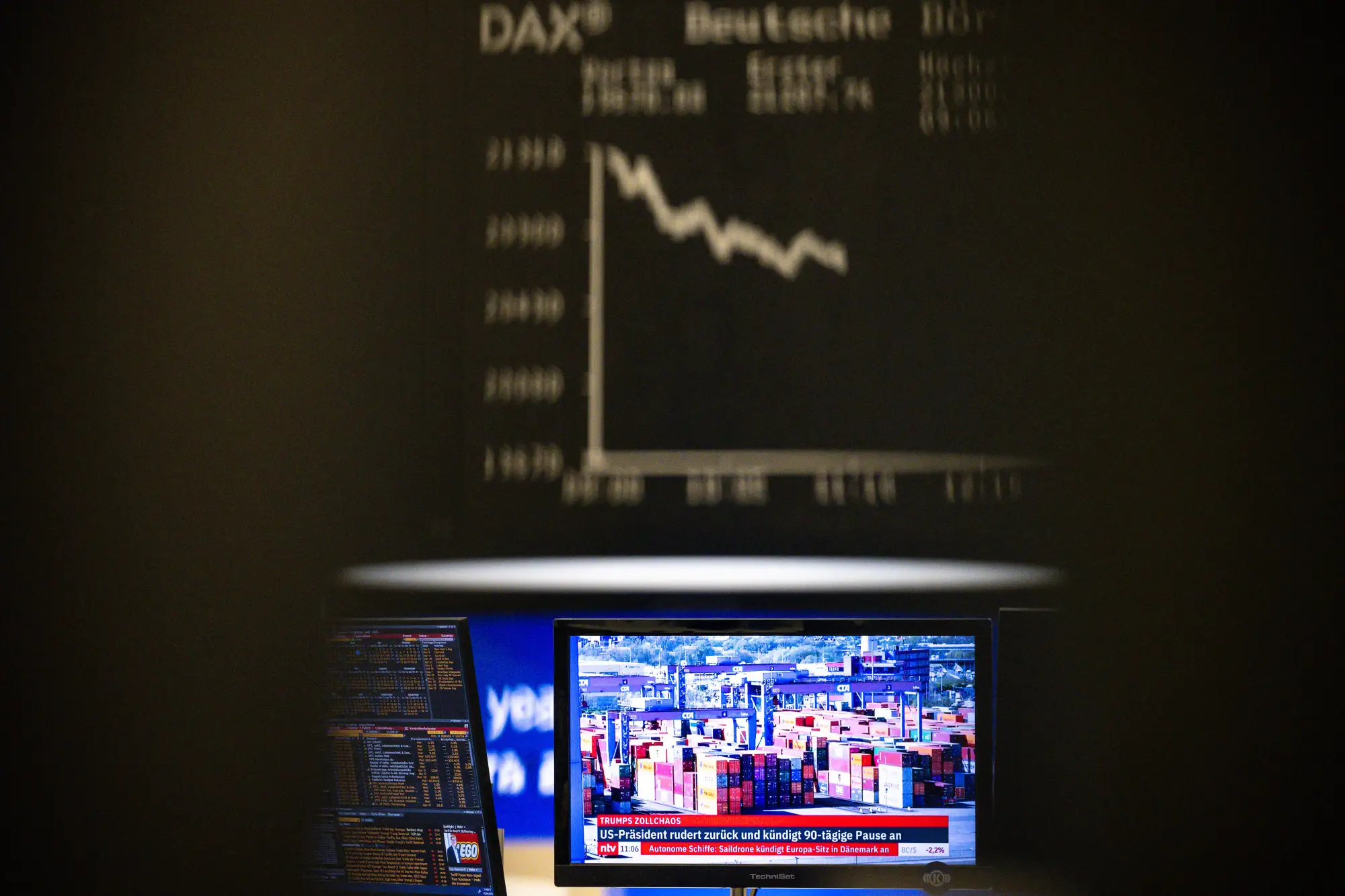 FRANKFURT AM MAIN, GERMANY - APRIL 10: A container port appears on a television screen at the Frankfurt Stock Exchange on April 10, 2025 in Frankfurt, Germany. The DAX surged over 7% as trading began this morning the day after U.S. President Donald Trump announced a 90-day pause on most of the punishing global tariffs he had previously imposed. (Photo by Florian Wiegand/Getty Images)