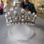 A bejeweled crown in a display case.