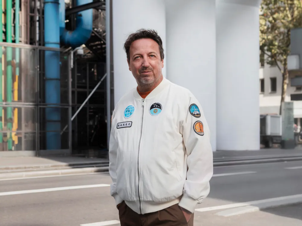 Portrait of a man outside a building.