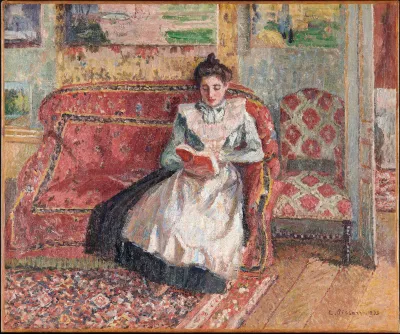 A painting of a woman sitting on a red couch reading a book.
