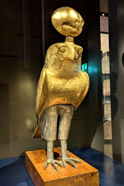 A status of Horus as a falcon with his top half in gold and his bottom half in silver.