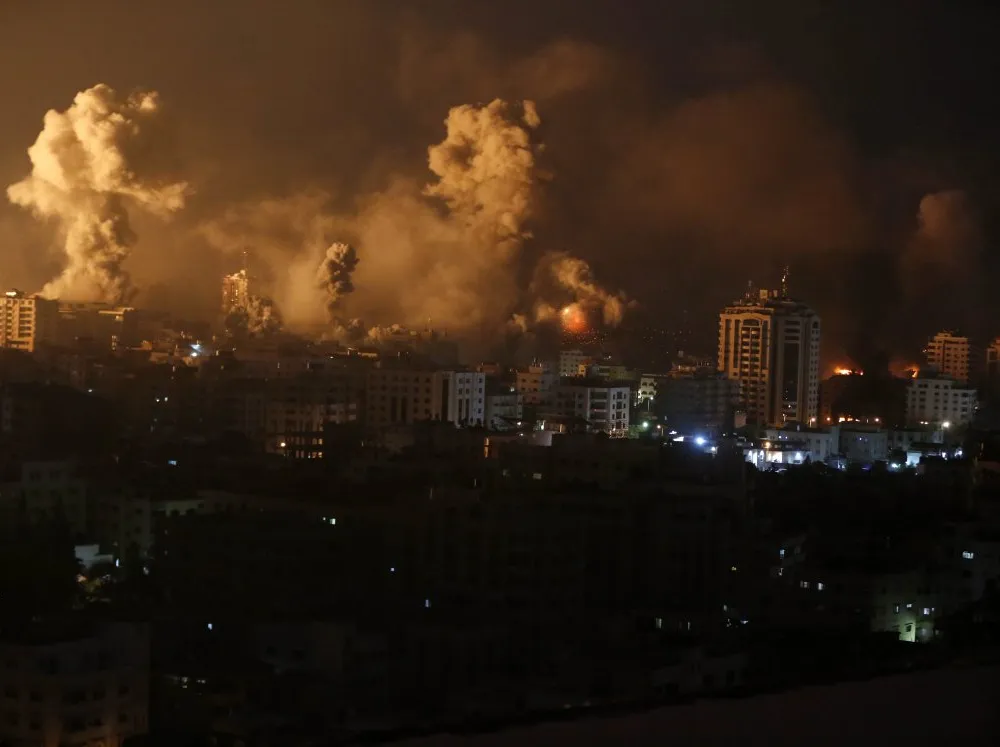 A desolate city scape with plumes of smoke.