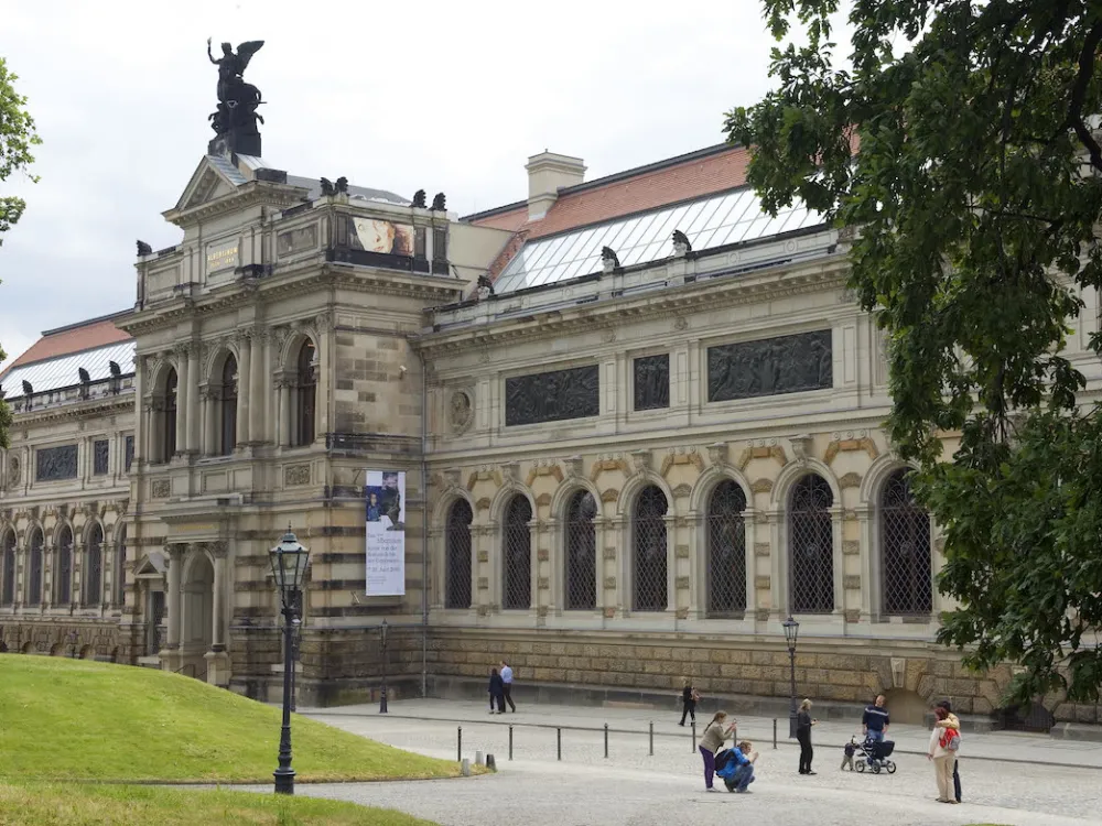A museum facade with people in front of it.