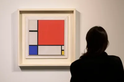 A woman staring at an abstract painting.