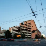 Intersection in Belgrade showing bombed Yugoslav Ministry of Defence building with traffic moving past was bombed on 7th May 1999 during Operation Allied Force