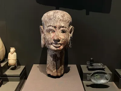 A carved wig stand in the shape of a woman