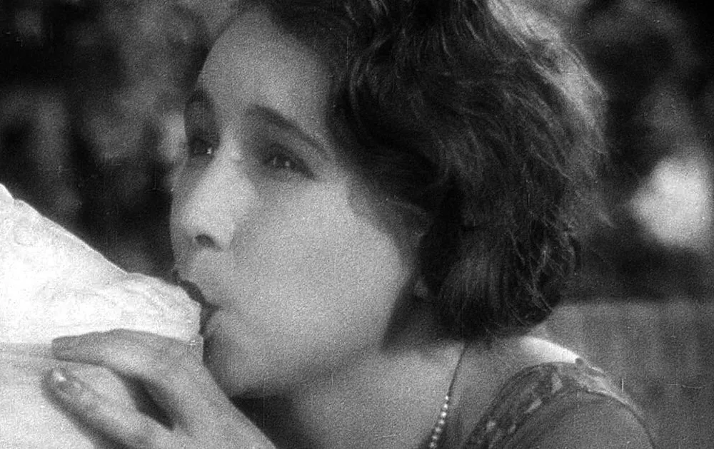 A woman sucking the toes of a statue.