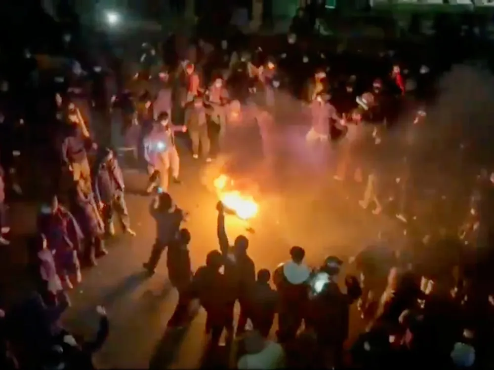 In this frame grab from footage circulating on social media shows protesters dancing and cheering around a bonfire as they take to the streets despite an intensifying crackdown as the Islamic Republic remains cut off from the rest of the world, in Tehran, Iran, Friday, Jan. 9, 2026.(UGC via AP)