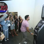 MIAMI BEACH, FL - DEC 3: Sajan Patel receives dollars from an ATM Leaderboard installation presented by Perrotin during Art Basel Miami Beach in the Miami Beach Convention Center on Saturday, December 3, 2022 in Miami Beach, Florida. (Photo by Sean Drakes/Getty Images)