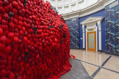 A pile of red gloves in a circular room.