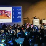 An auctioneer auctions off a work by Safeya Binzagr.