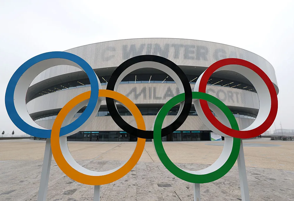blue, yellow, black, green, and red interlocking rings outside of a an arena