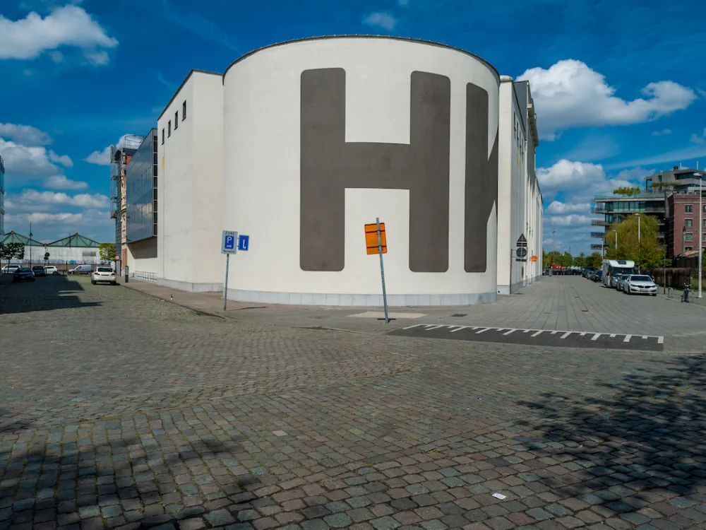 A museum facade with a giant H on one rounded wall.