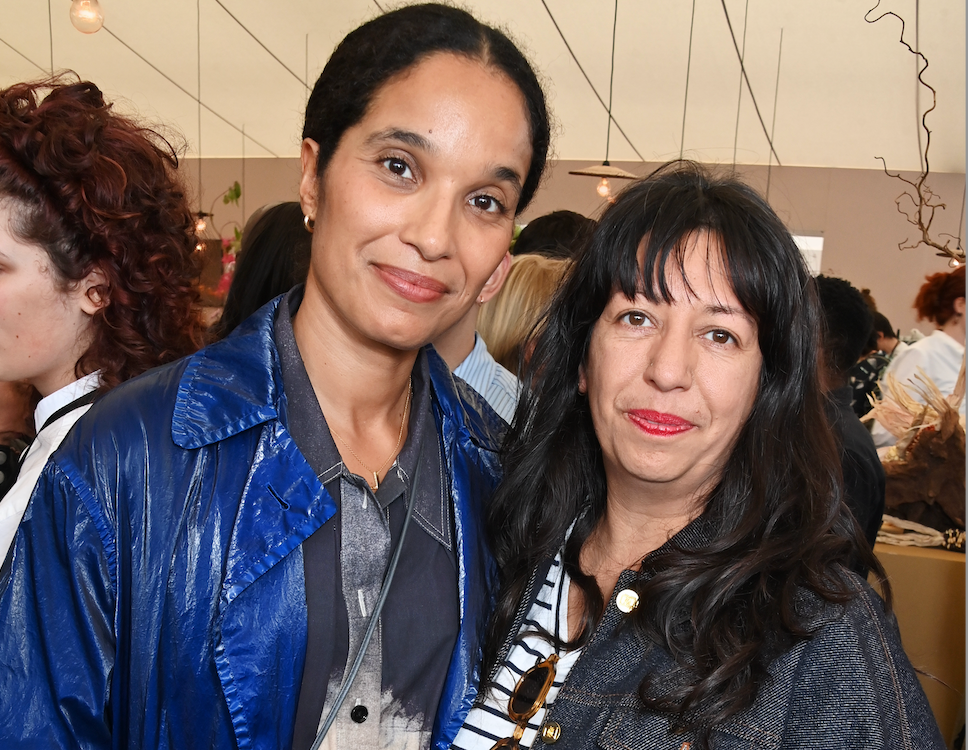 Two women smiling at the camera.