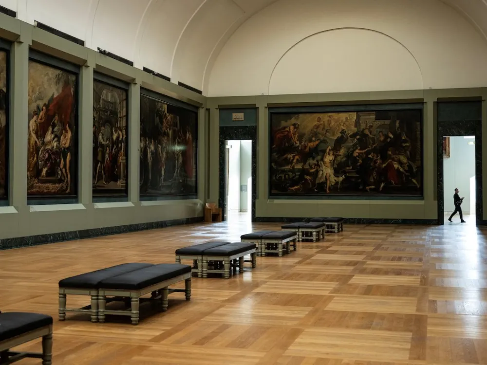 A large gallery filled with tall paintings.