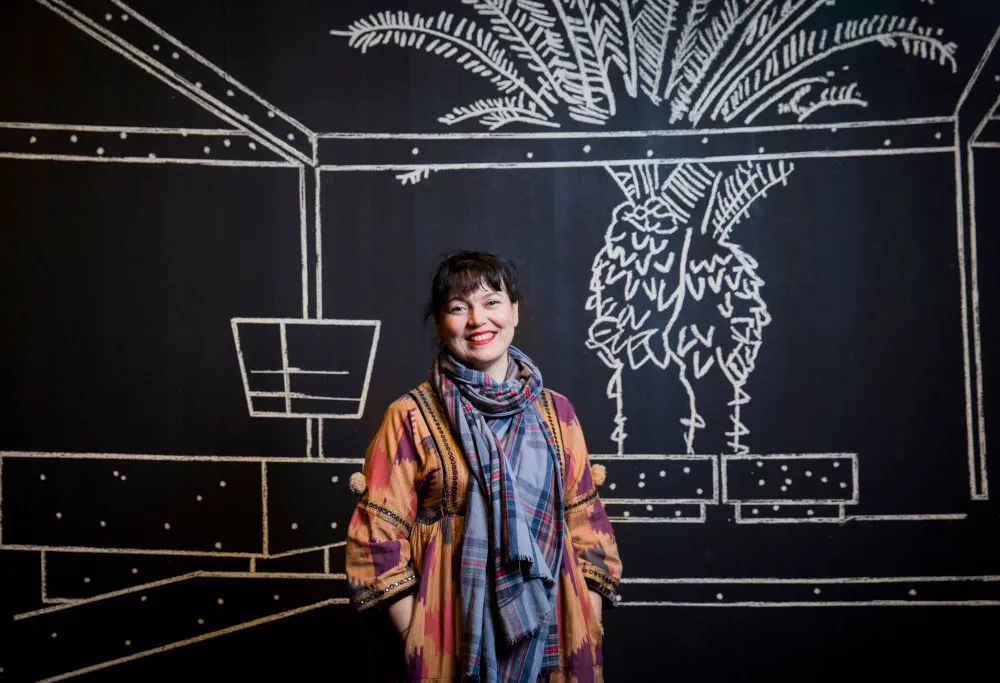 Yto Barrada standing in her exhibition 