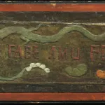 horizontal wood panel with a reddish border. On the left is a crouching nude female figure painted green, and on the right are two heads with long hair and a white animal