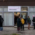 People gather on the street at the opening of Poland