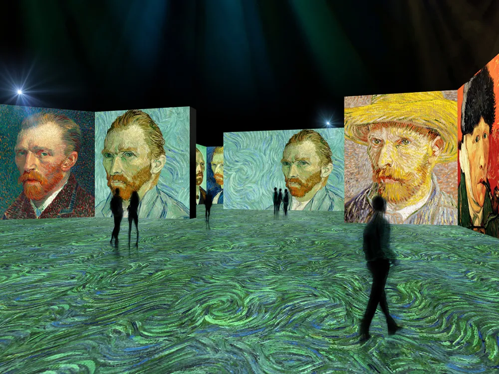 In a digital rendering, silhouetted figures walk among projections of Van Gogh
