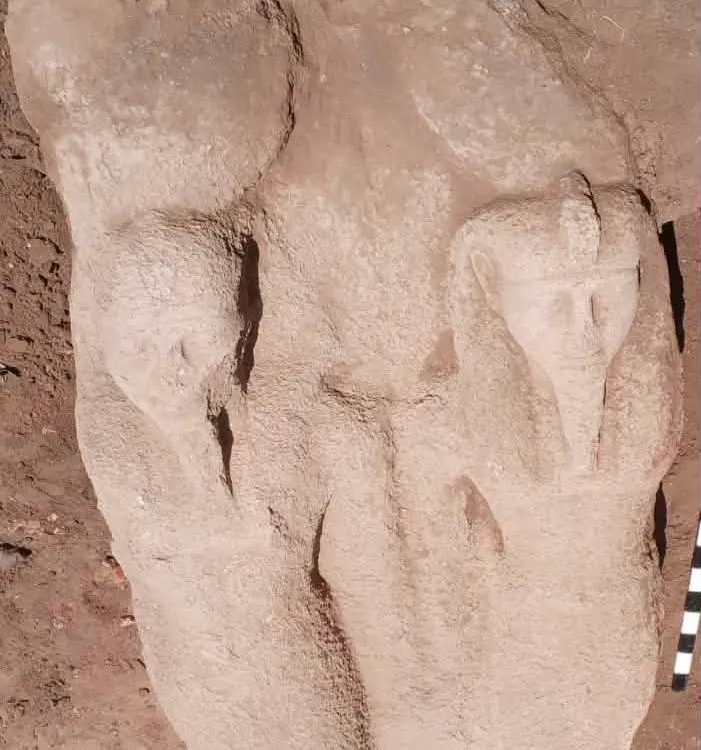 rough stone statue showing ramses II formed in sandstone