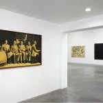 A gallery with photographs on its walls.