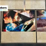 View of a photo-based installation with images layered over pieces of copper.