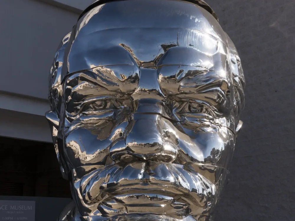 Chrome bust of Russian Communist leader Vladimir Lenin in West Hollywood, California. The piece is "Miss Mao Trying to Poise Herself at the Top of Lenin