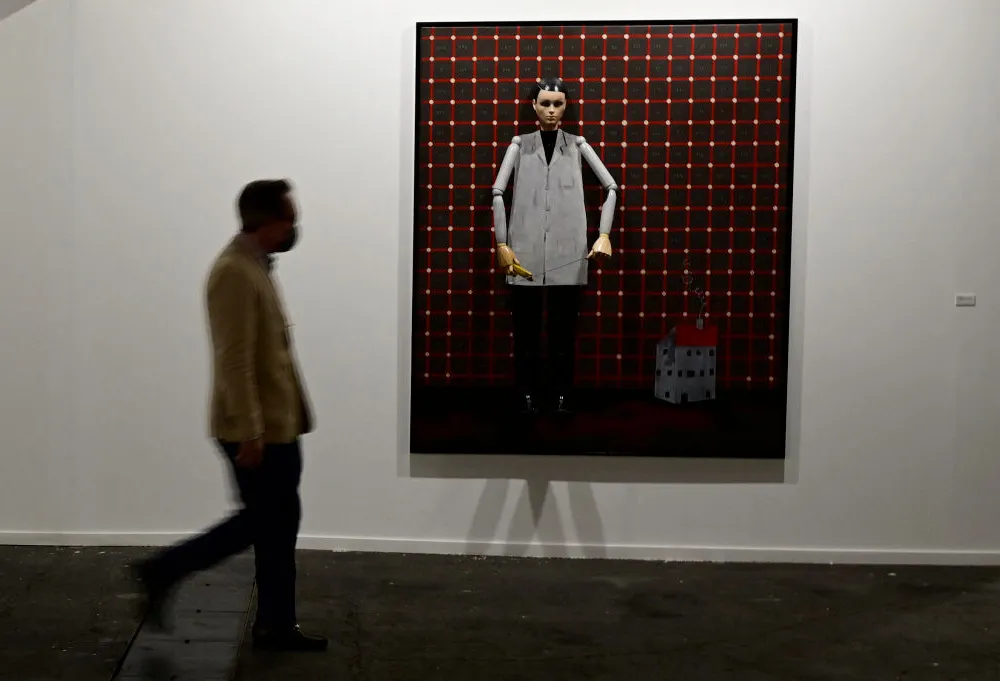 A visitor walks past an artwork by German artist Thomas Zipp at the International Contemporary Art Fair