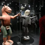 Two sculptures in a vitrine.