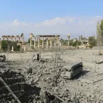 TOPSHOT - This picture shows damaged cars and debris at the site of an Israeli airstrike that targeted Baalbek in Lebanon