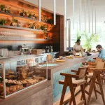 A counter with people sitting and working at it.
